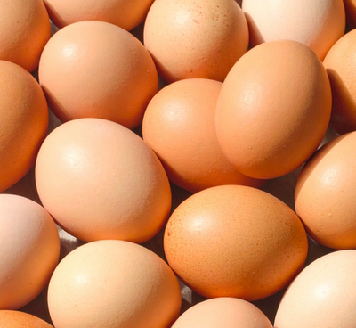 Close-up of a pile of brown eggs