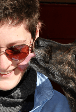 person being licked by dog