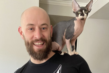 Man with cat on his shoulder